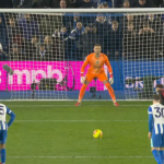 “Brighton’s Charalampos Kostoulas scoring a stoppage-time overhead kick against Bournemouth in the Premier League, with the ball soaring toward the goal and goalkeeper attempting to save.”